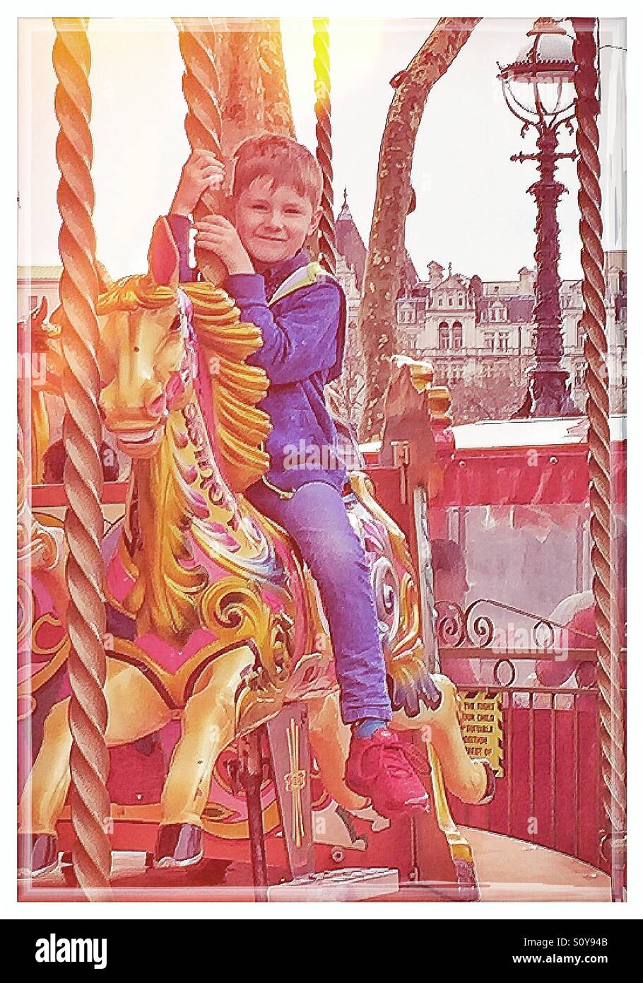 Boy on a carousel Stock Photo