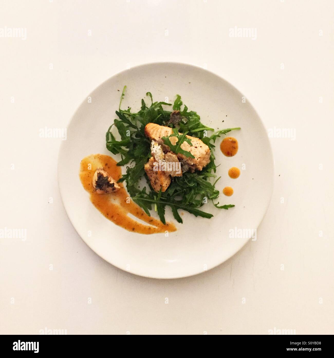 Healthy salmon fillet on a bed of rocket salad - buon appetito! Stock Photo