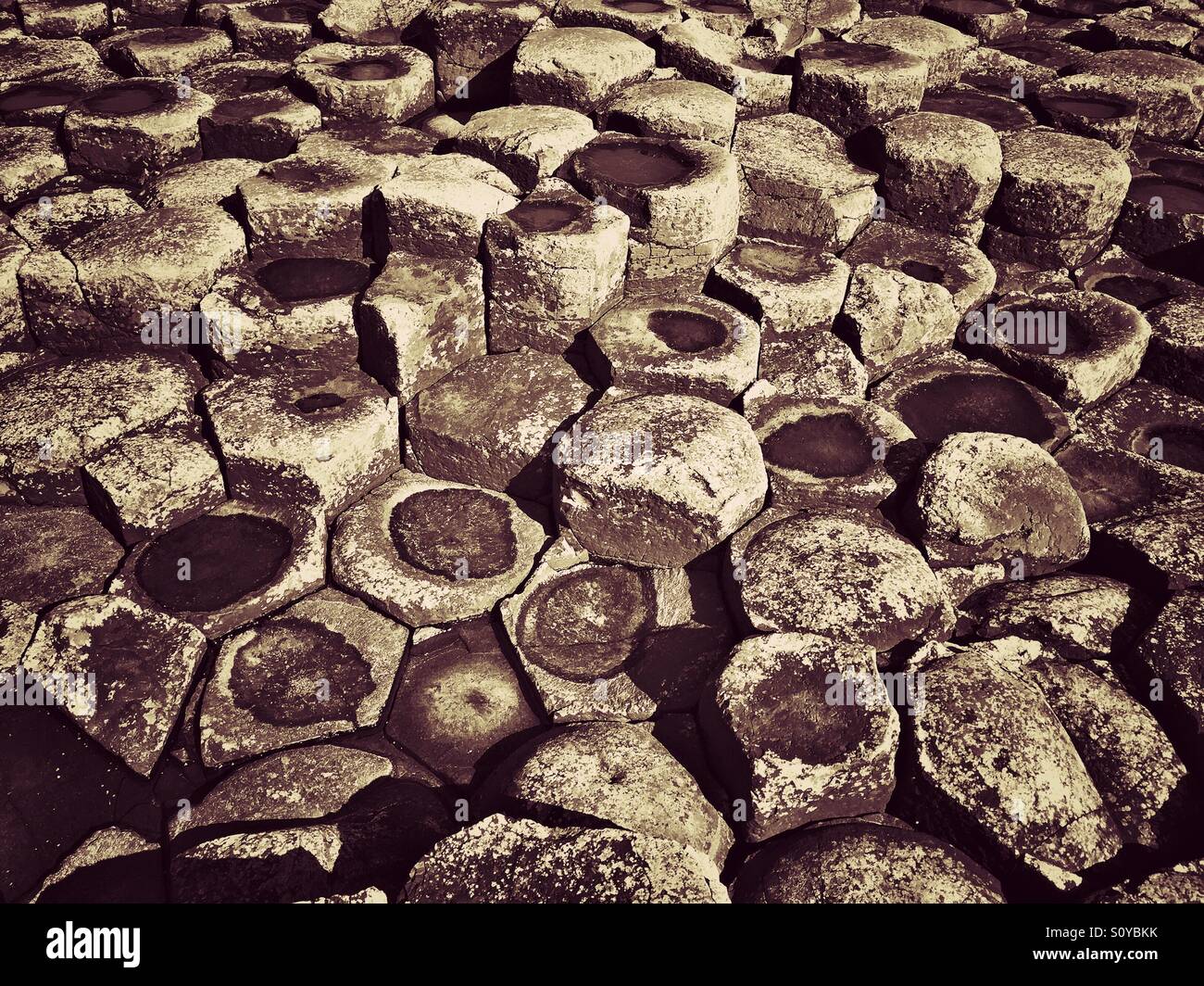 A Grunge Effect View of Interlocking Basalt Columns at Giant's Causeway, Co. Antrim, Northern Ireland. These columns are a result of Volcanic Activity possibly 60 million years ago. © COLIN HOSKINS. Stock Photo