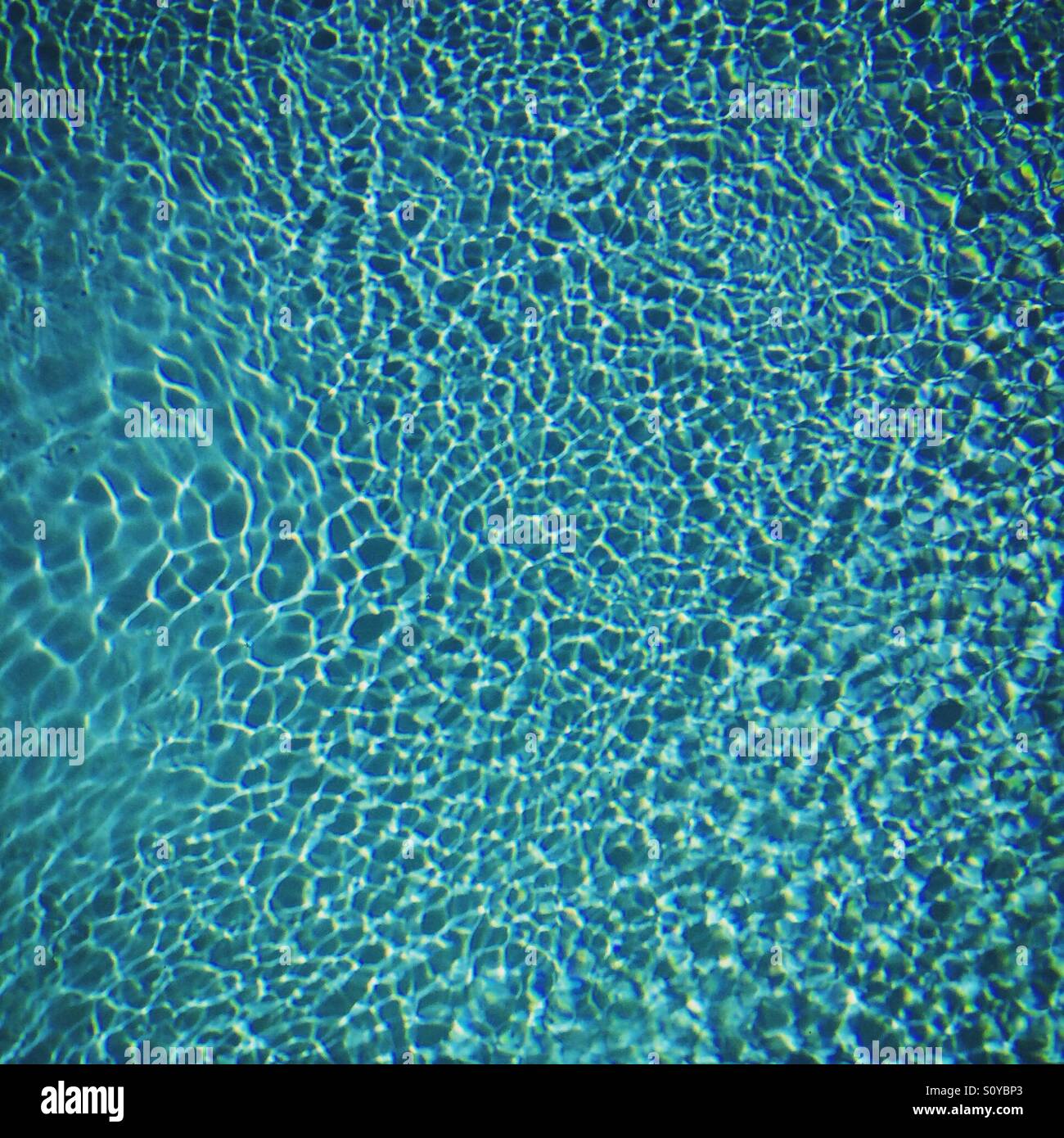 Swimming pool ripples background texture. Mobile phone photo with some phone or tablet post processing. - Smartphone Captured Stock Image