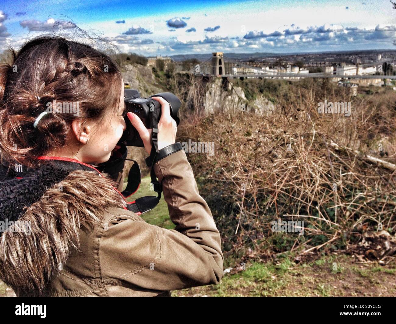 Girl taking photo of Bristol suspension bridge - Smartphone Captured Stock Image