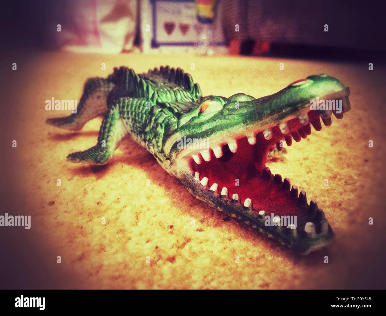 A toy crocodile on the floor. - Smartphone Captured Stock Image