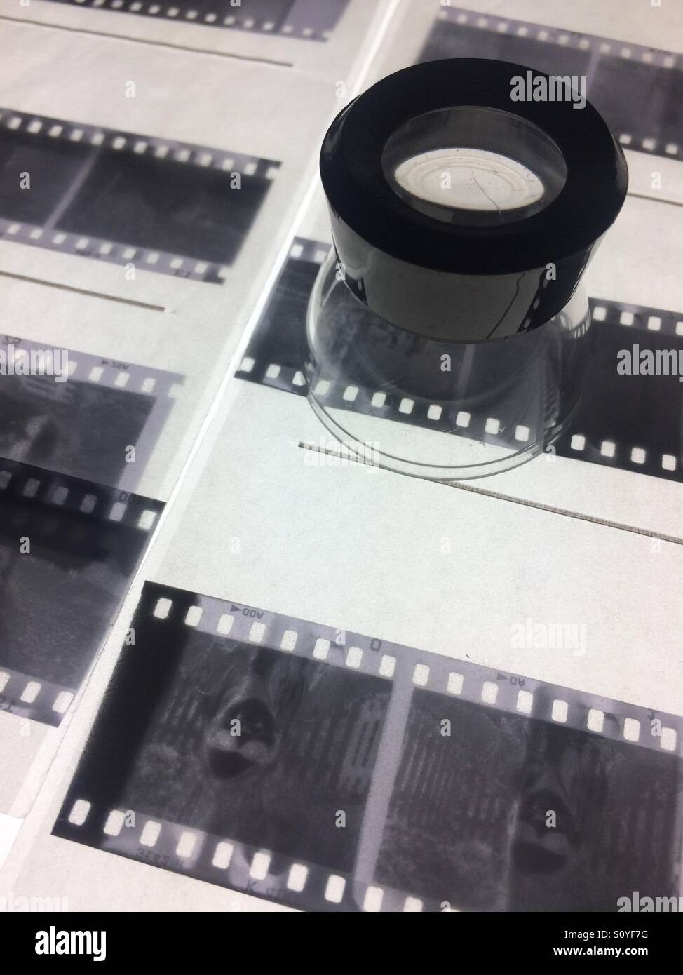 Loupe and film photography negatives - Smartphone Captured Stock Image