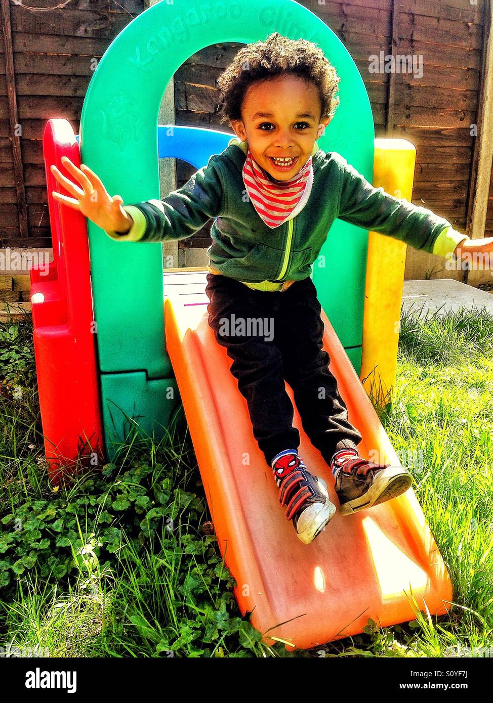 Boy playing on a slide. Stock Photo