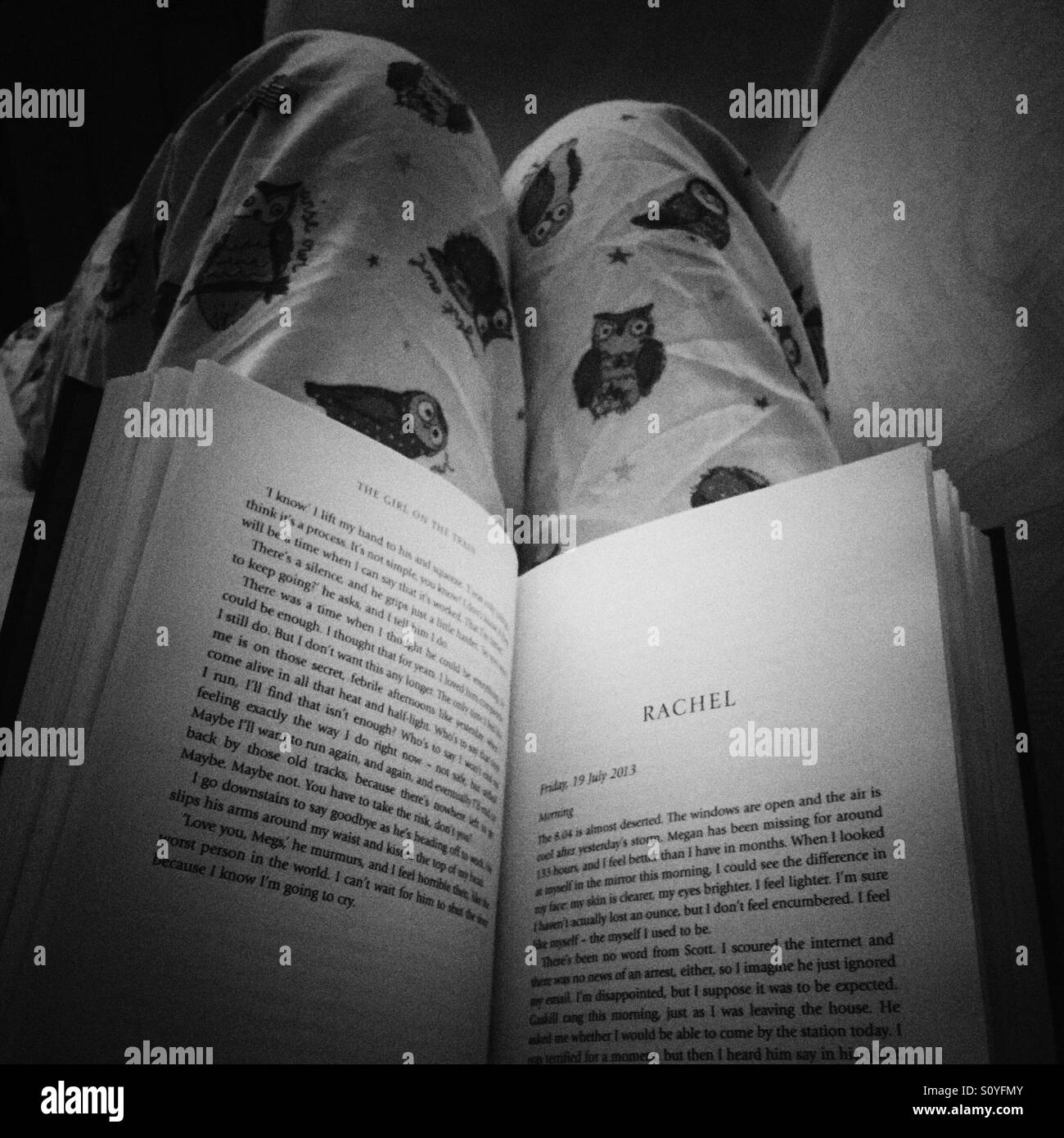 Girl reading a book wearing pyjamas Stock Photo