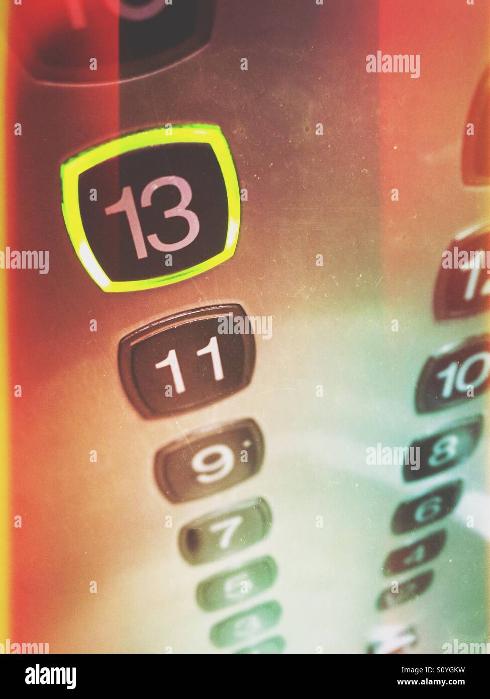 13th floor button pushed in elevator Stock Photo