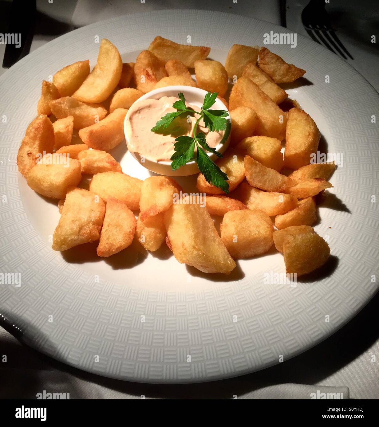 Patatas bravas on a white plate Stock Photo