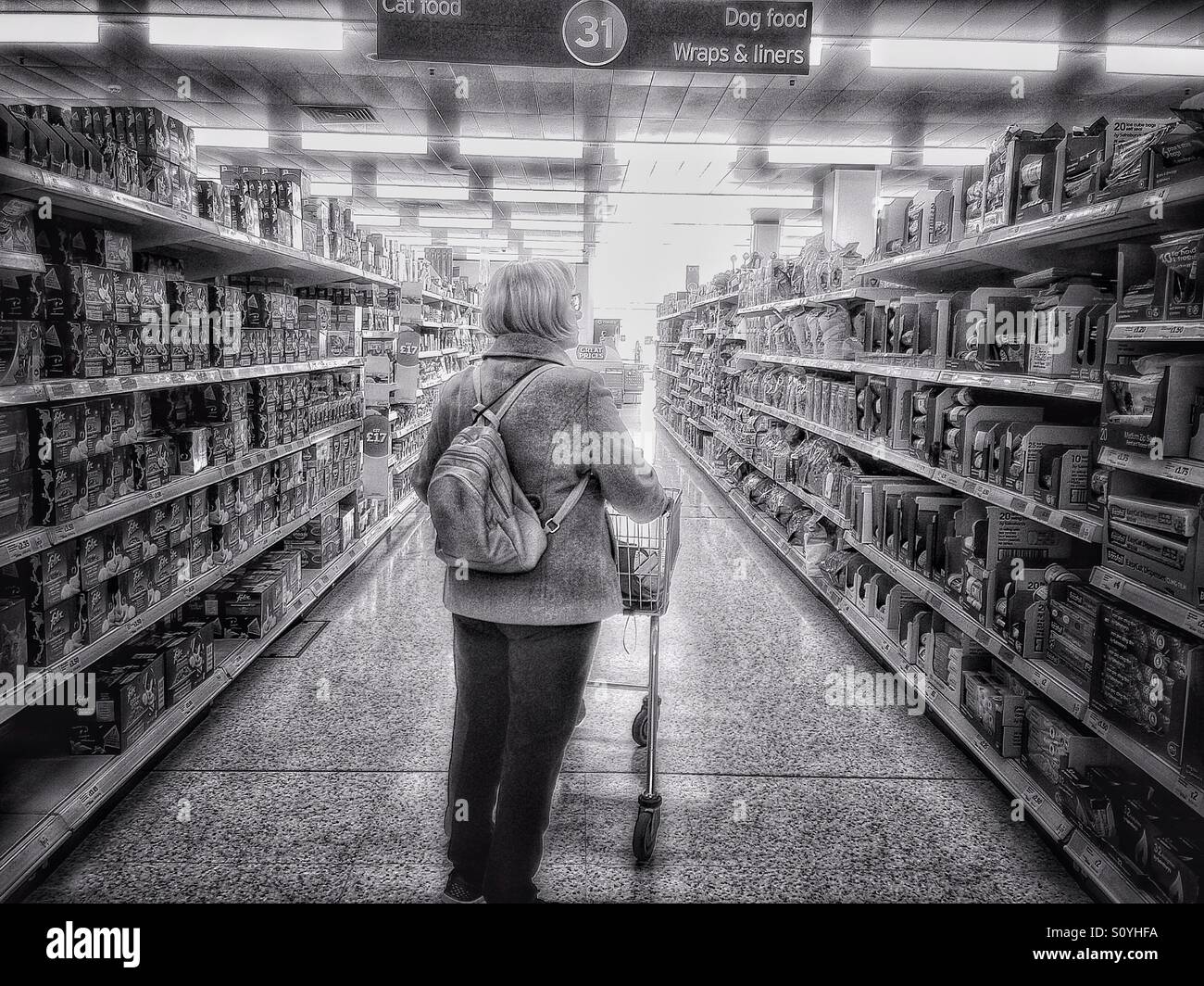 Middle aged woman in a supermarket aisle. - Smartphone Captured Stock Image