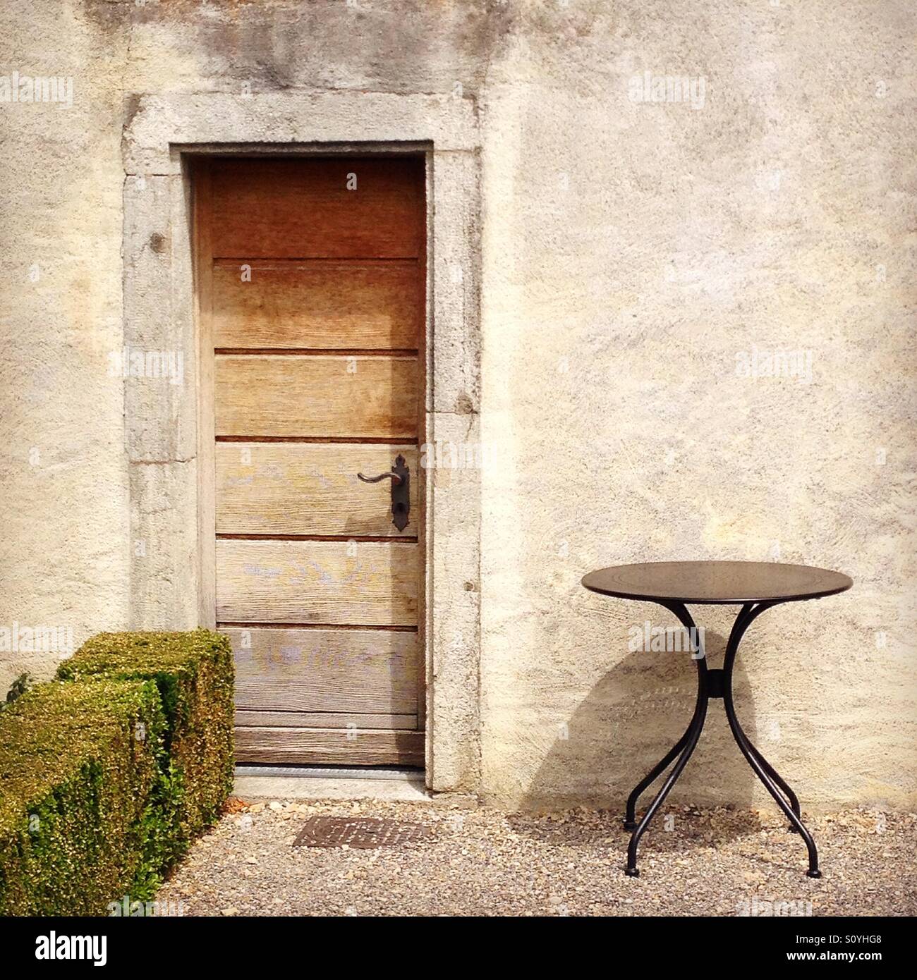 Small table beside a door Stock Photo - Alamy