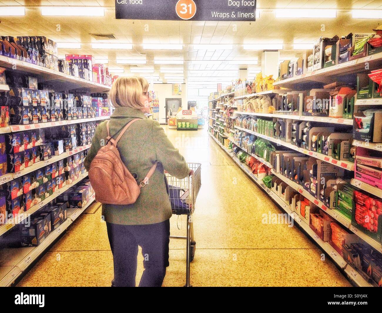 Middle aged woman in supermarket aisle. - Smartphone Captured Stock Image