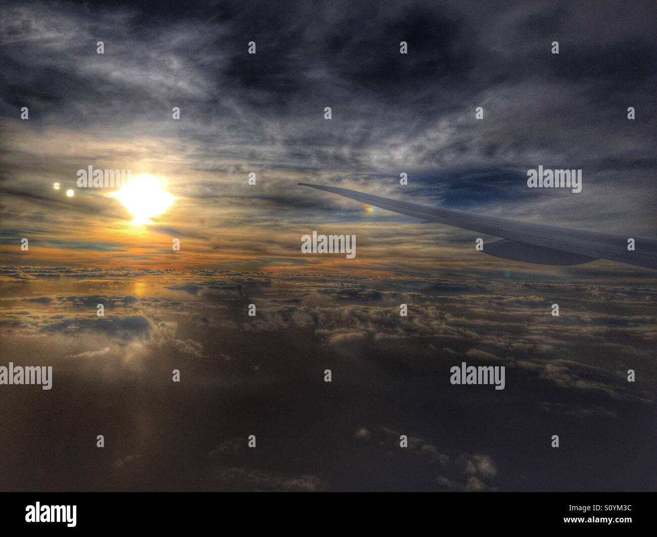 Sunset from airplane with Wing in photo - Smartphone Captured Stock Image