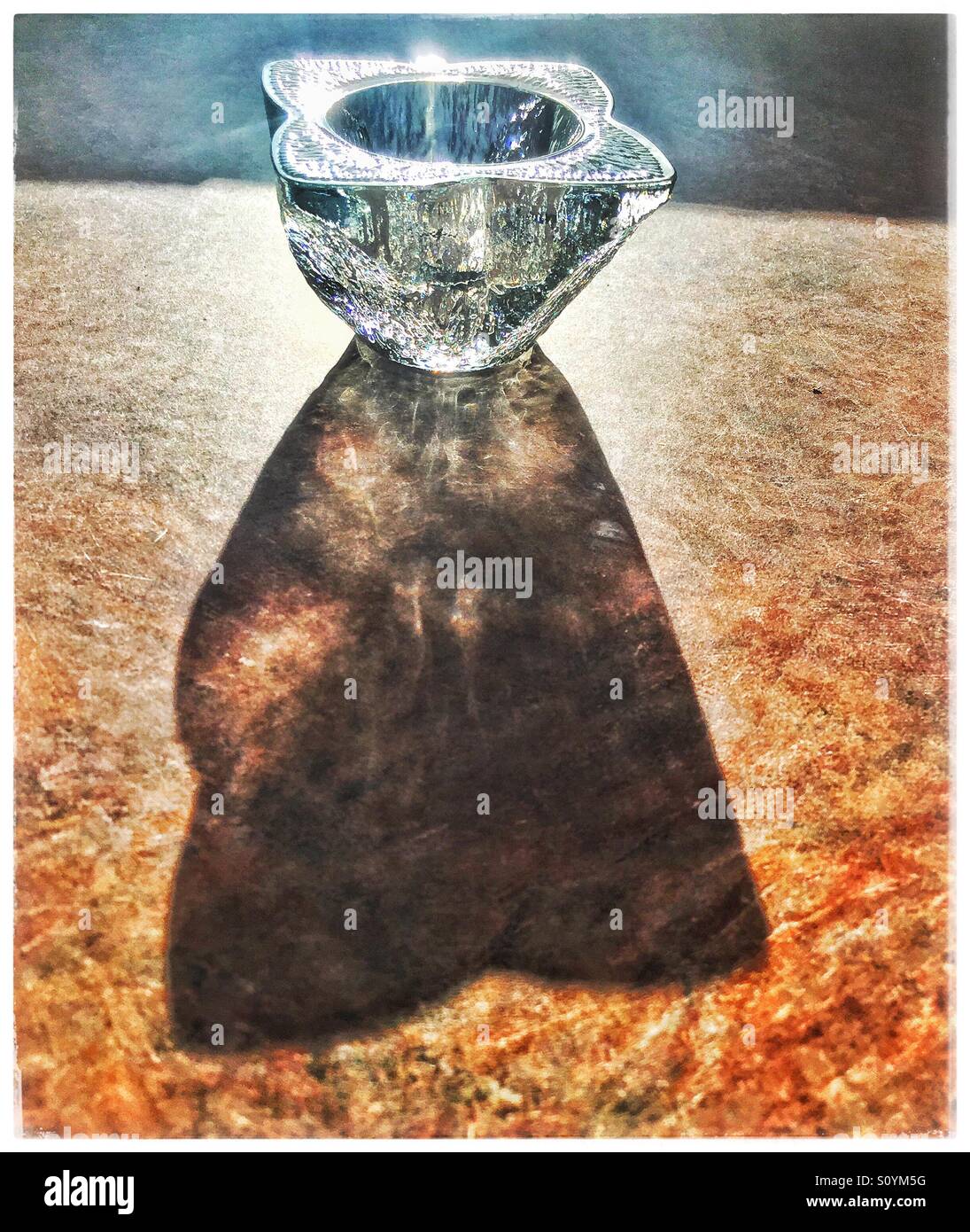 Crystal candle holder casting a long shadow Stock Photo Alamy