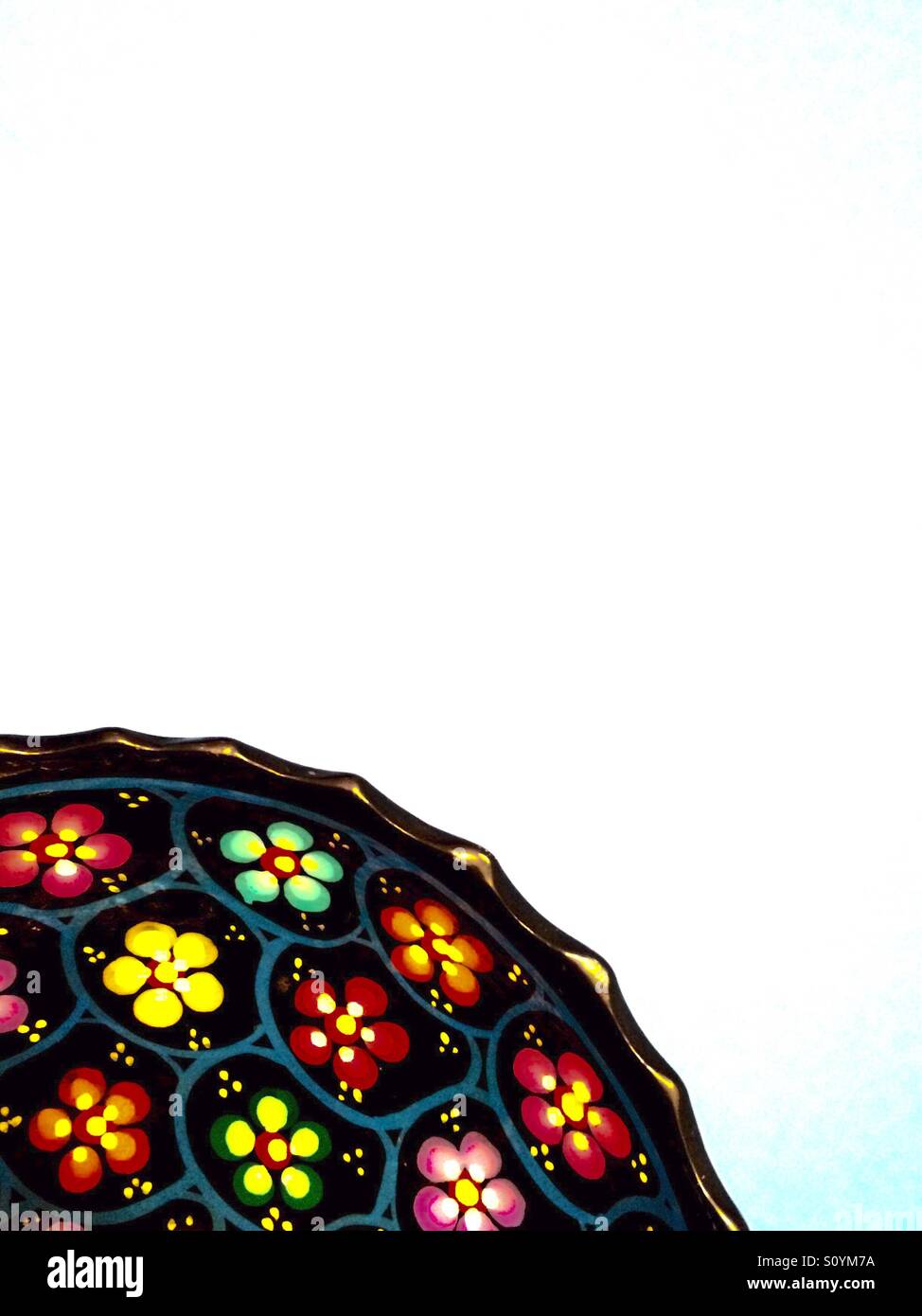 Hand painted dish with floral pattern bottom left - Smartphone Captured Stock Image