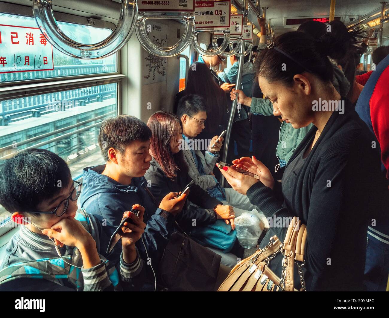 Chinese people in subway using smartphones - Smartphone Captured Stock Image