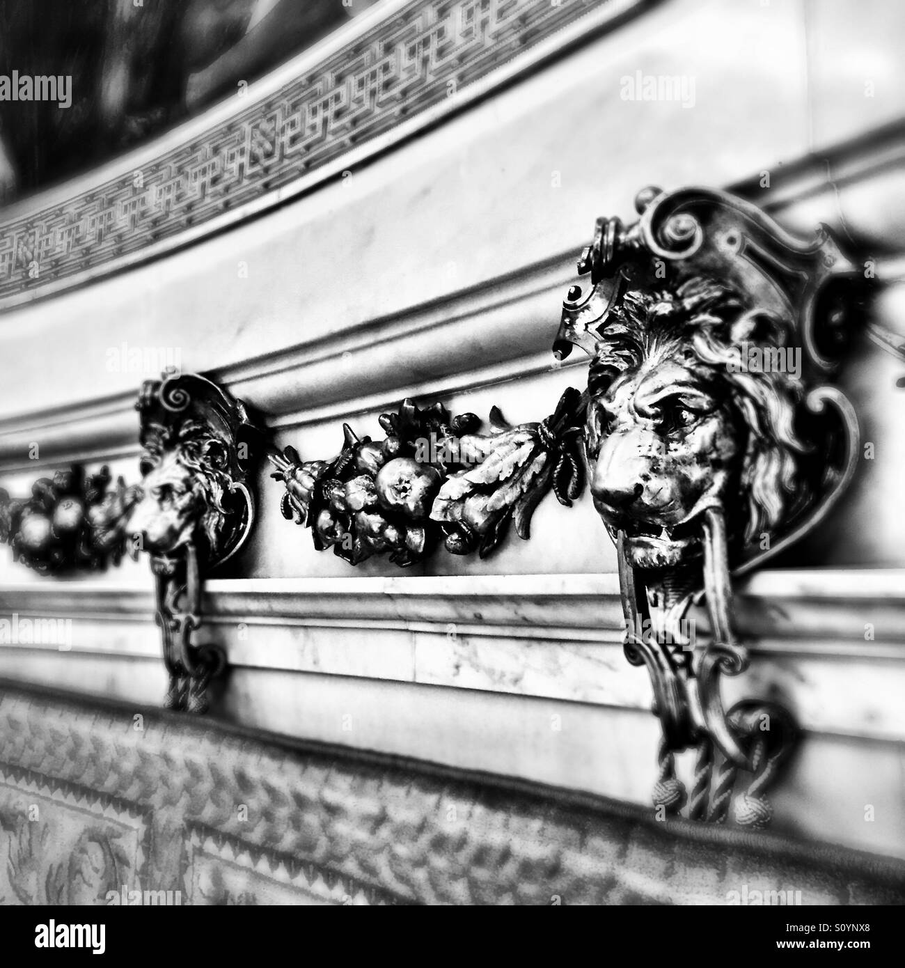 Lion statues holding locks lining the the room of a royal chamber Stock