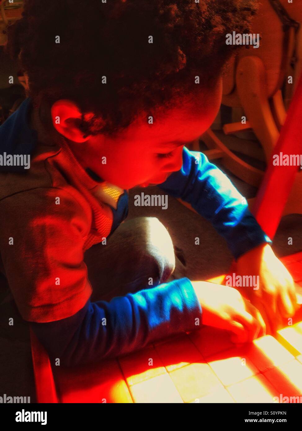 Boy playing with coloured bricks. - Smartphone Captured Stock Image