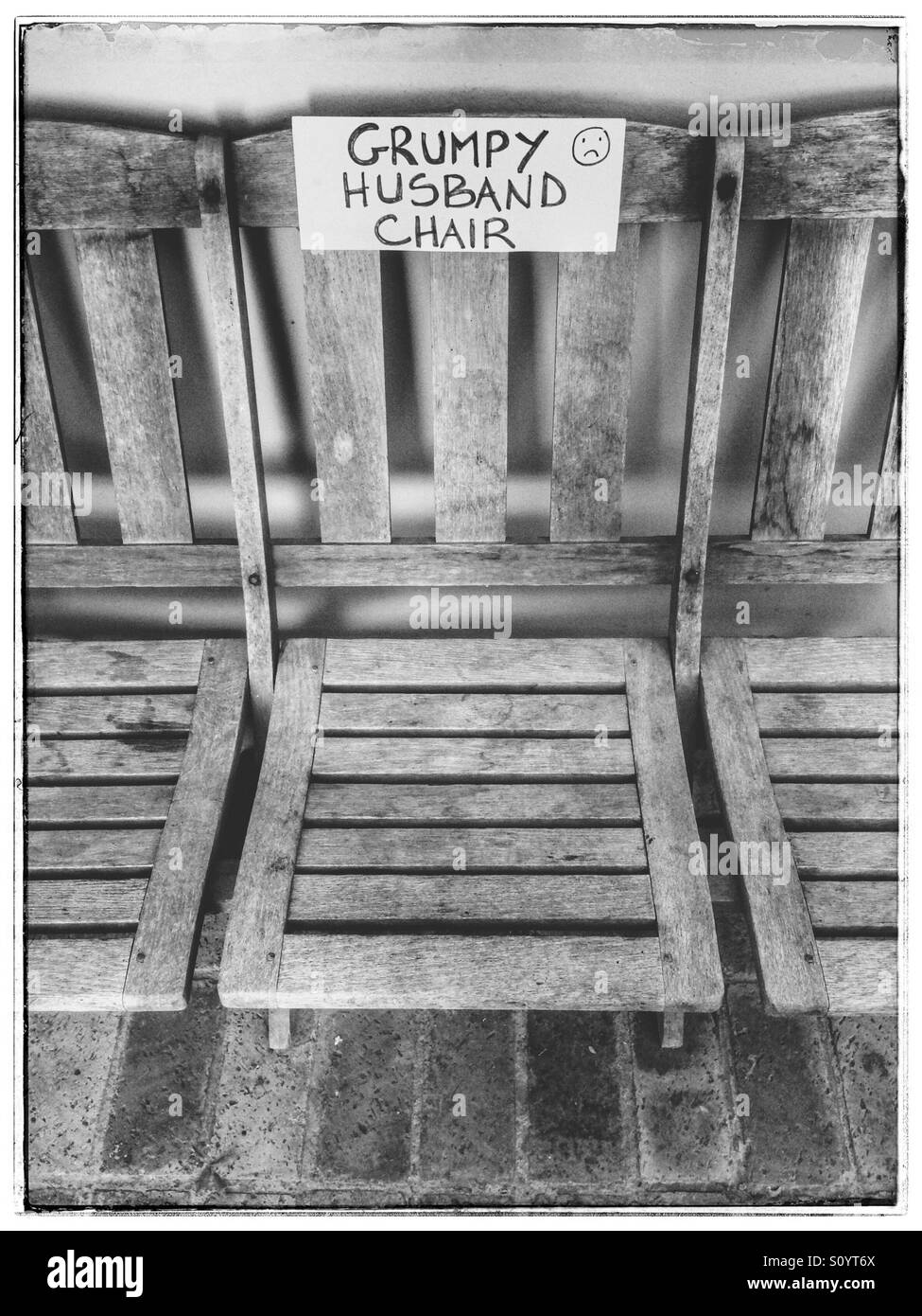 Black and white photo of grumpy husband chair sign Stock Photo Alamy
