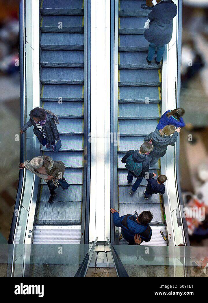 People going up and down a mechanical escalator - Smartphone Captured Stock Image