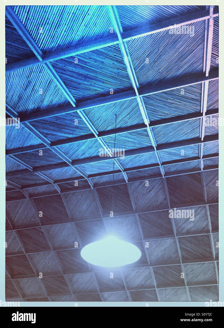 Ceiling light hanging from a bamboo and wood ceiling - Smartphone Captured Stock Image