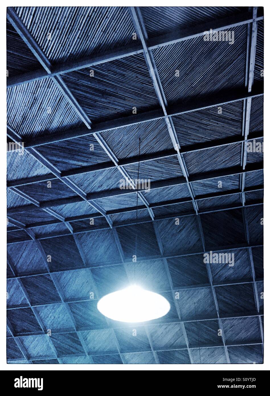 Ceiling light hanging from a bamboo and wood ceiling - Smartphone Captured Stock Image