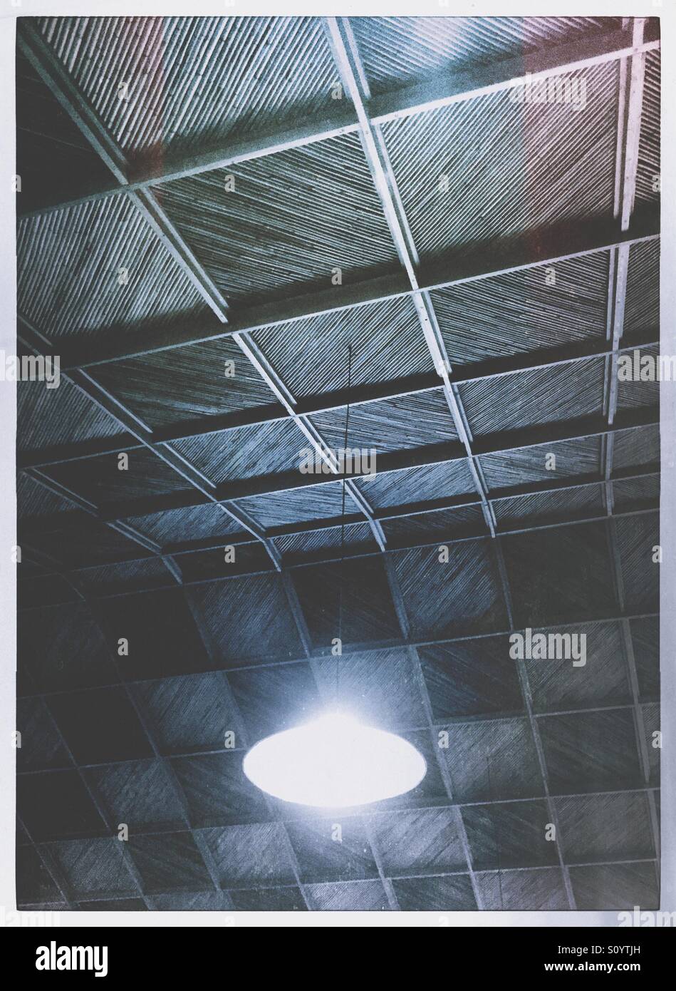 Ceiling light hanging from a bamboo and wood ceiling - Smartphone Captured Stock Image