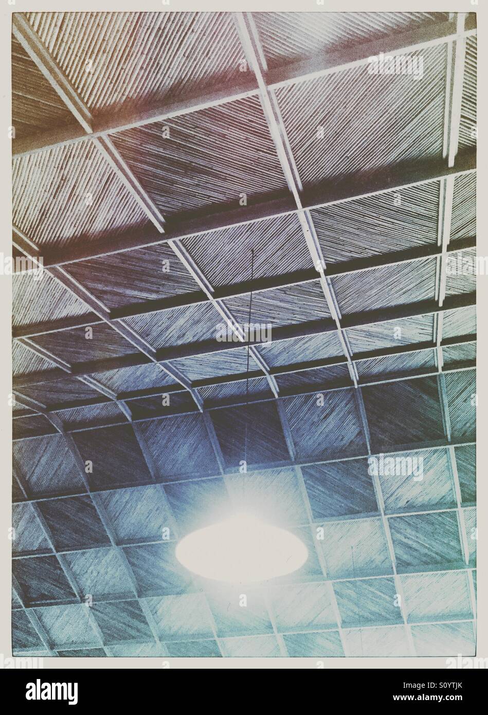 Ceiling light hanging from a bamboo and wood ceiling - Smartphone Captured Stock Image