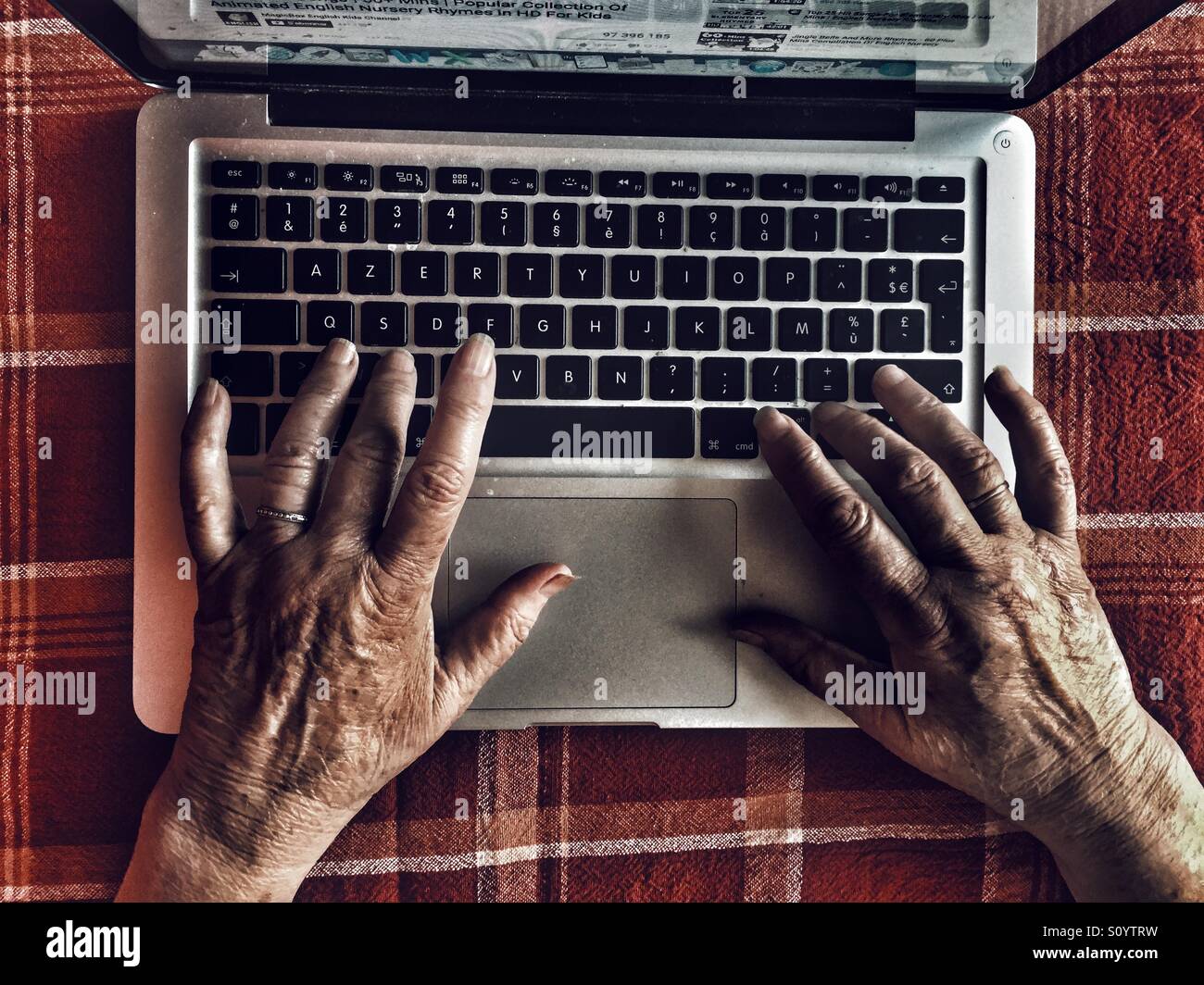 Old woman using laptop - Smartphone Captured Stock Image