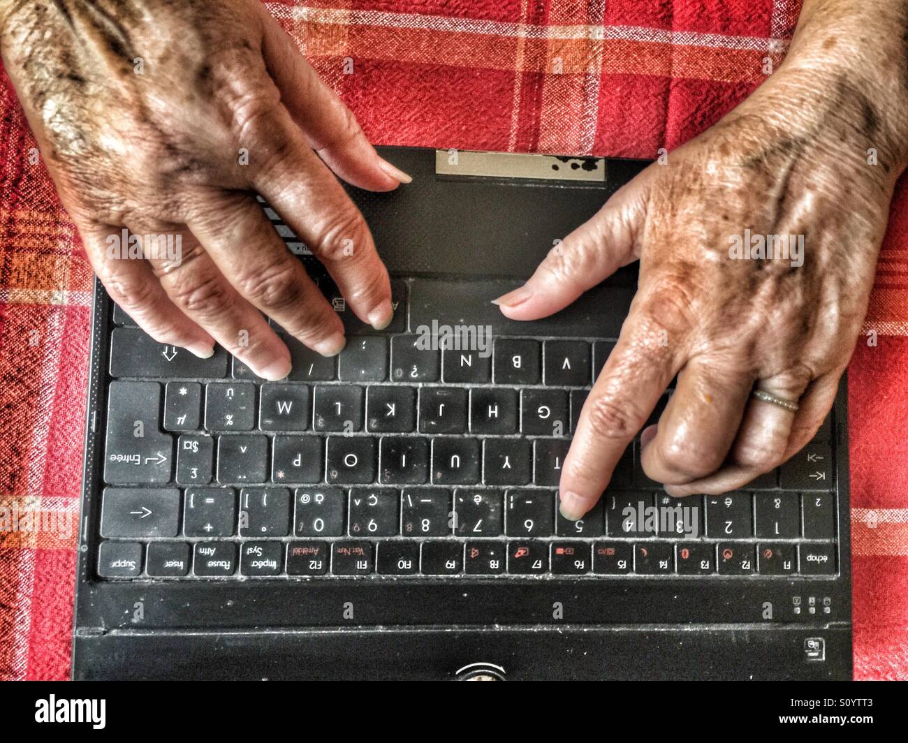 Senior using computer - Smartphone Captured Stock Image