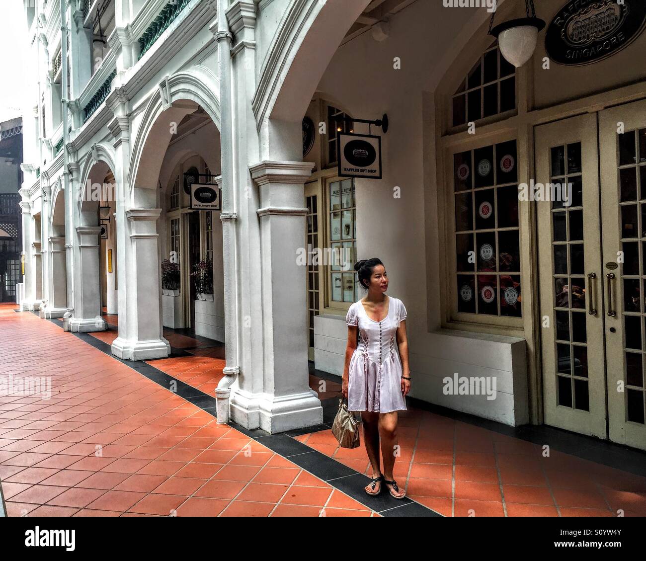 Model posing near Raffles Hotel Singapore Stock Photo