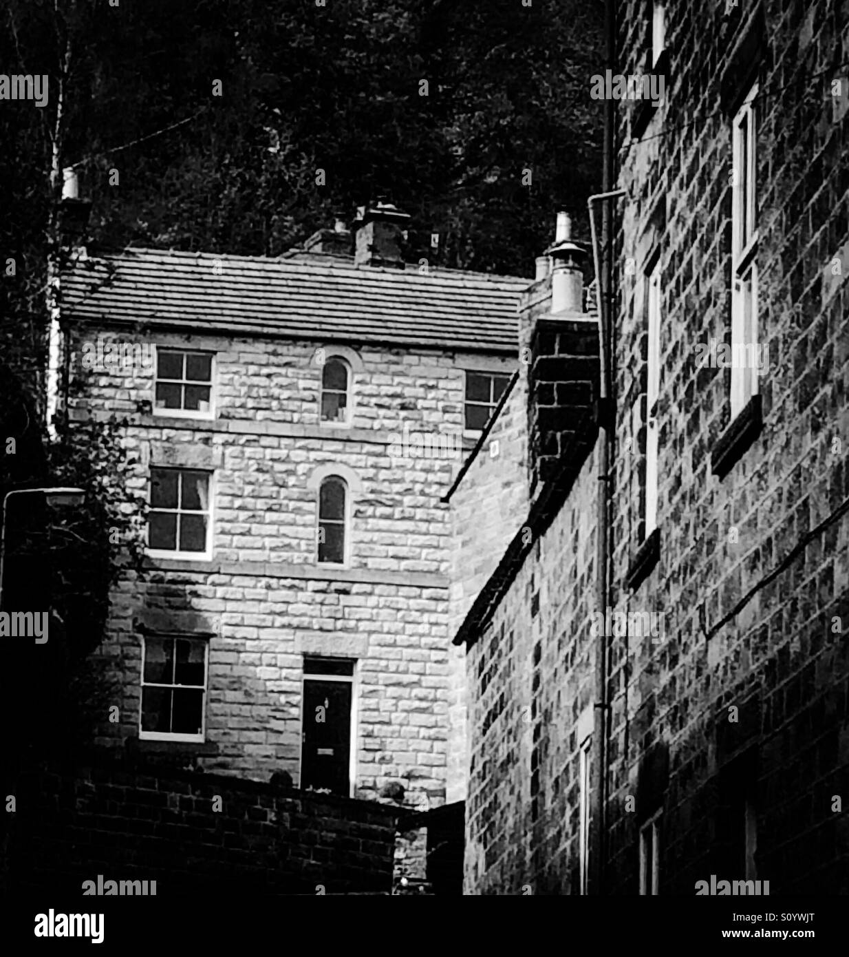 Black and white photograph of houses in Matlock Bath a village in the Derbyshire Peak District England UK - Smartphone Captured Stock Image