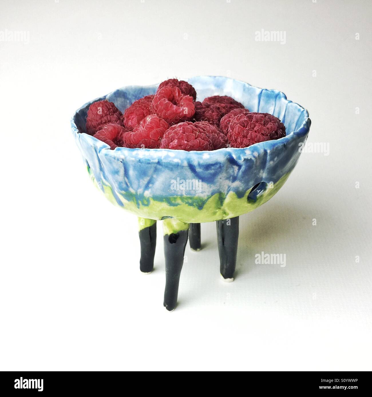 handmade ceramic berry bowl with fresh raspberries Stock Photo