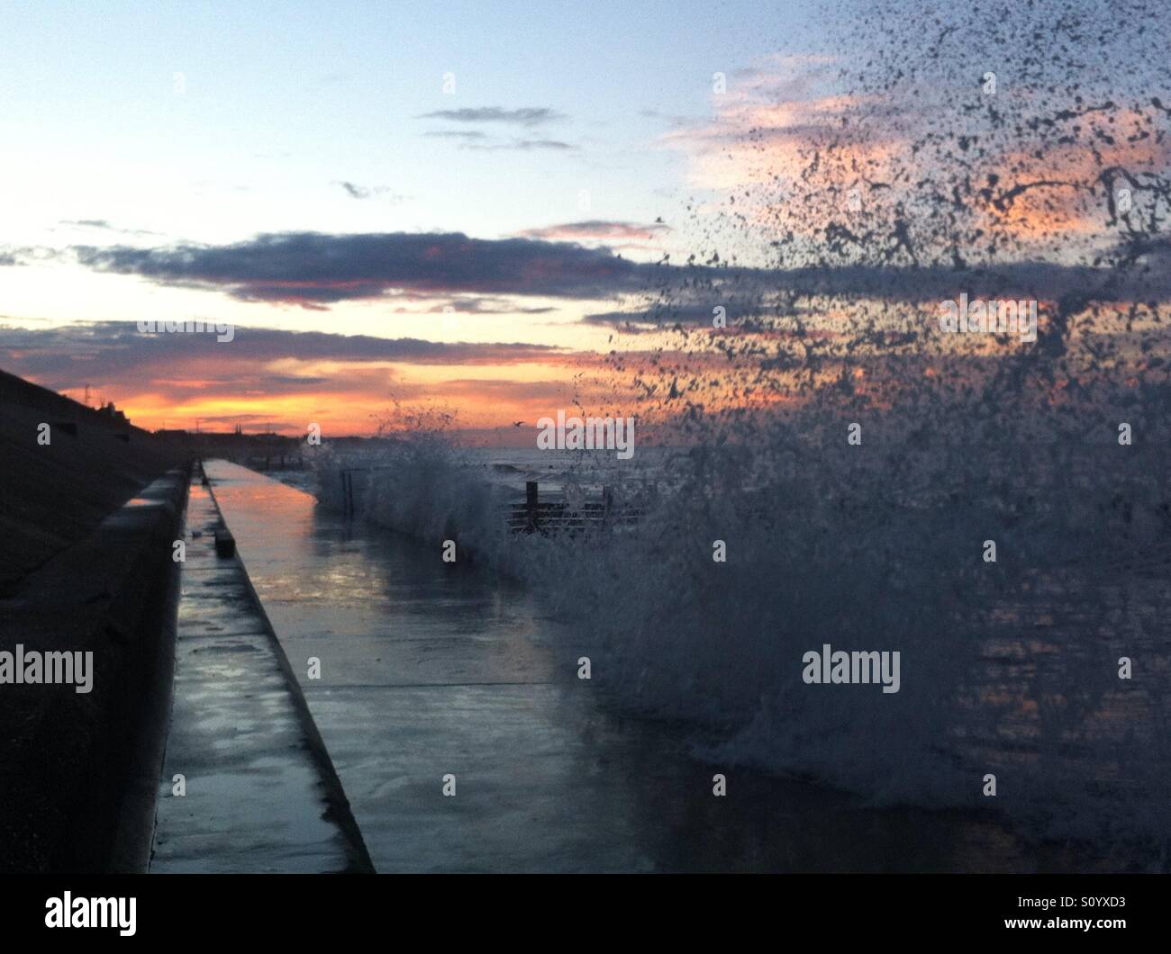 High tide at the sea front at sunset - Smartphone Captured Stock Image