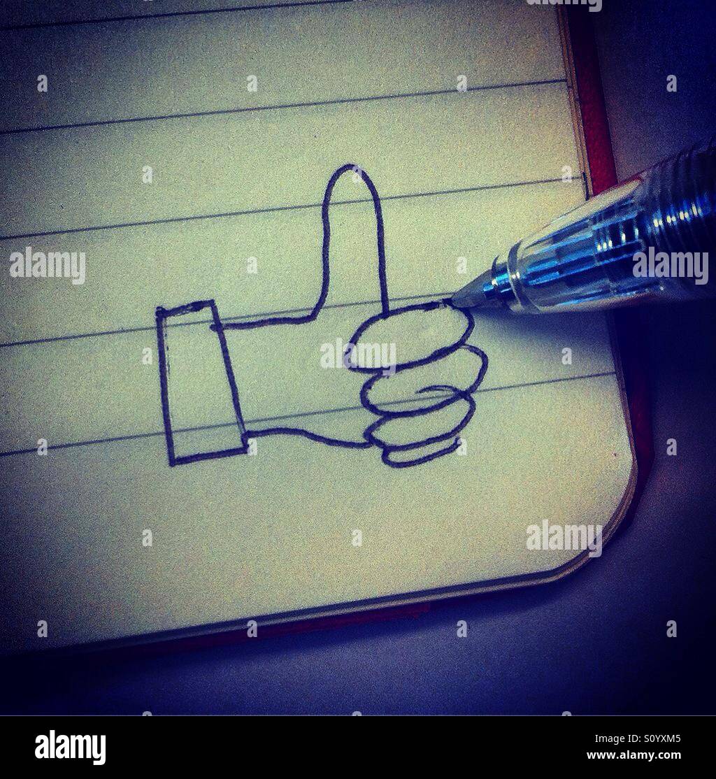 Drawing a like thumb up in the corner of a booknote with a pencil Stock ...