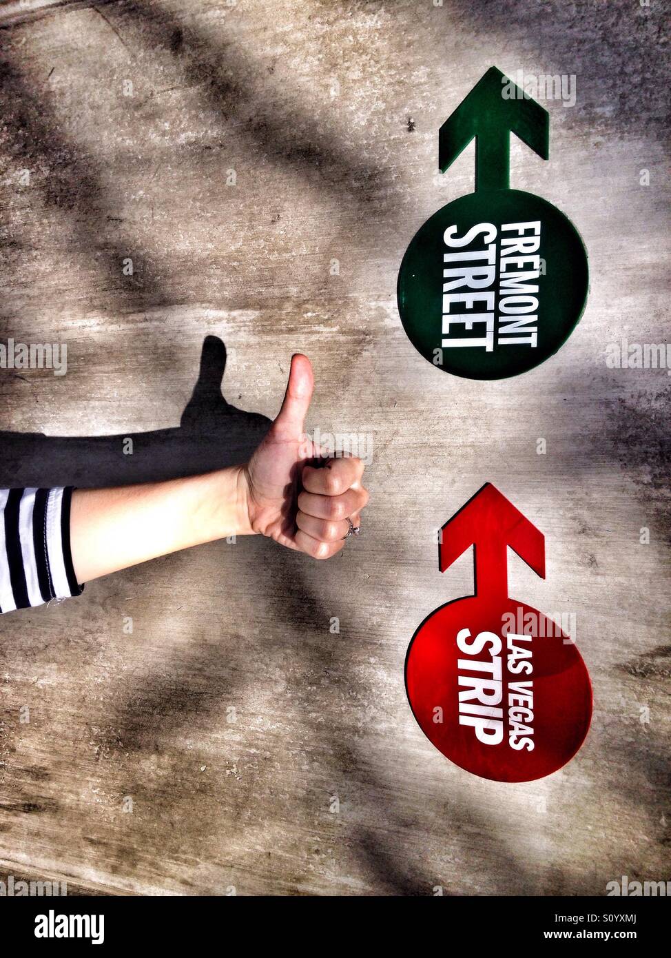 Arrows showing direction and a hand showing thumb up - Smartphone Captured Stock Image