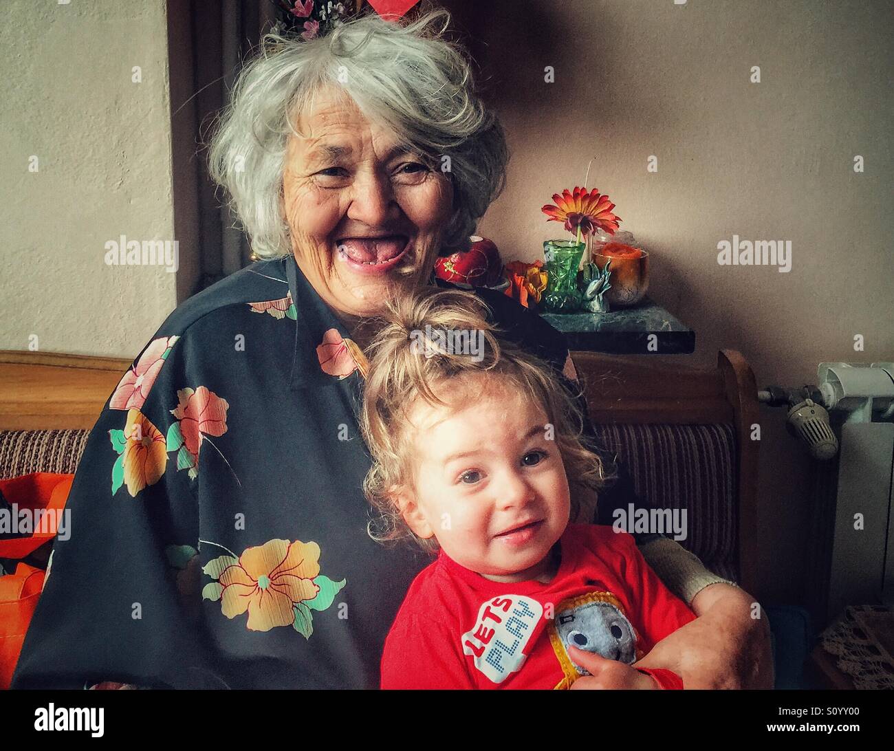 Grandmother and baby girl smiling and looking at camera - Smartphone Captured Stock Image