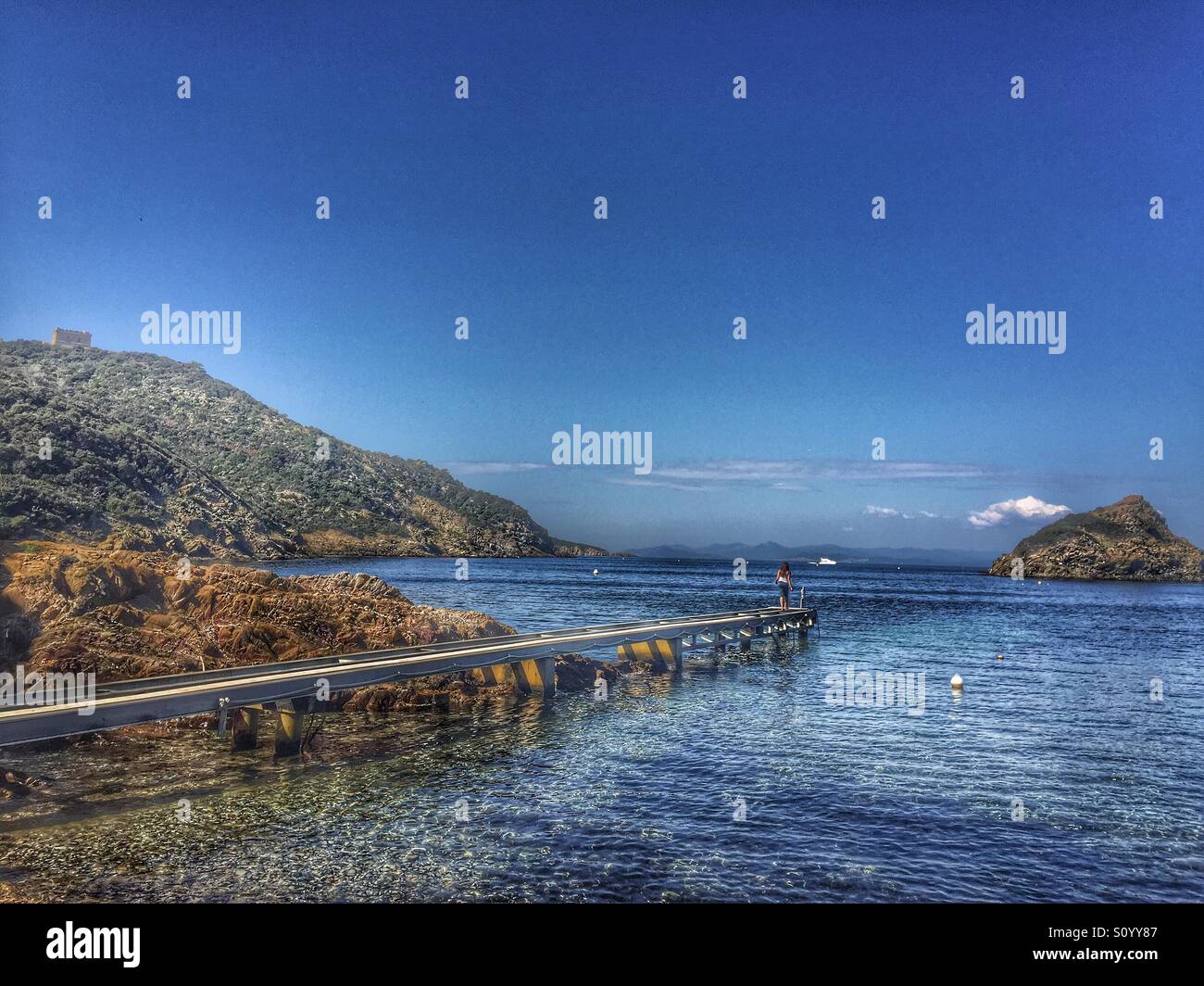 Woman at end of dock, Porquerolles island, Côte d'Azur,France - Smartphone Captured Stock Image