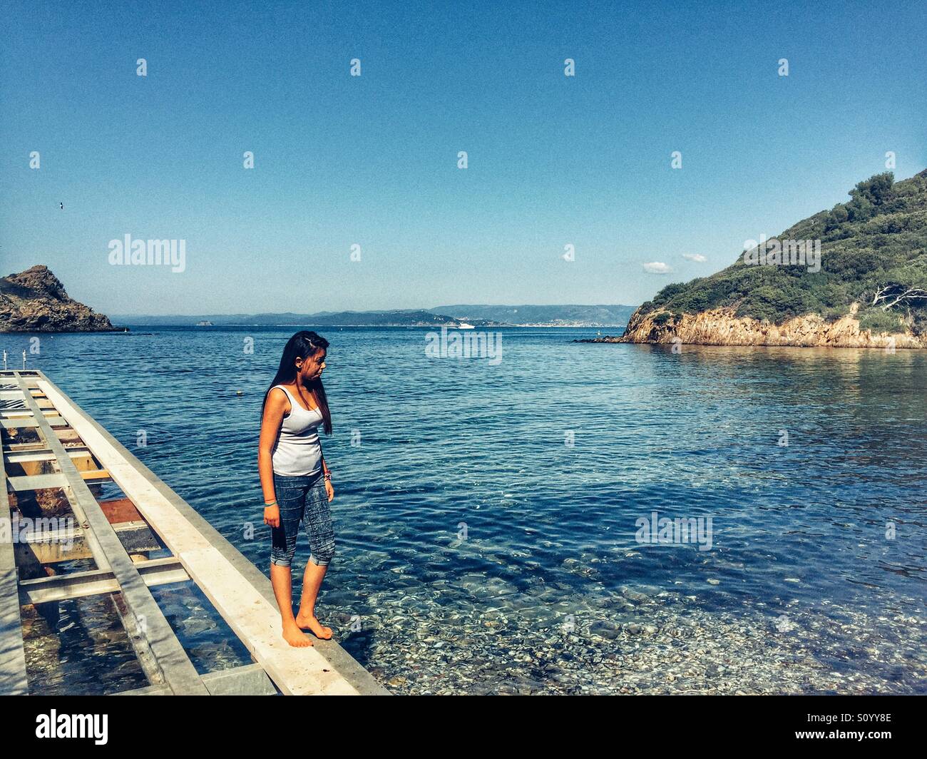 Woman on jetty Porquerolles France - Smartphone Captured Stock Image