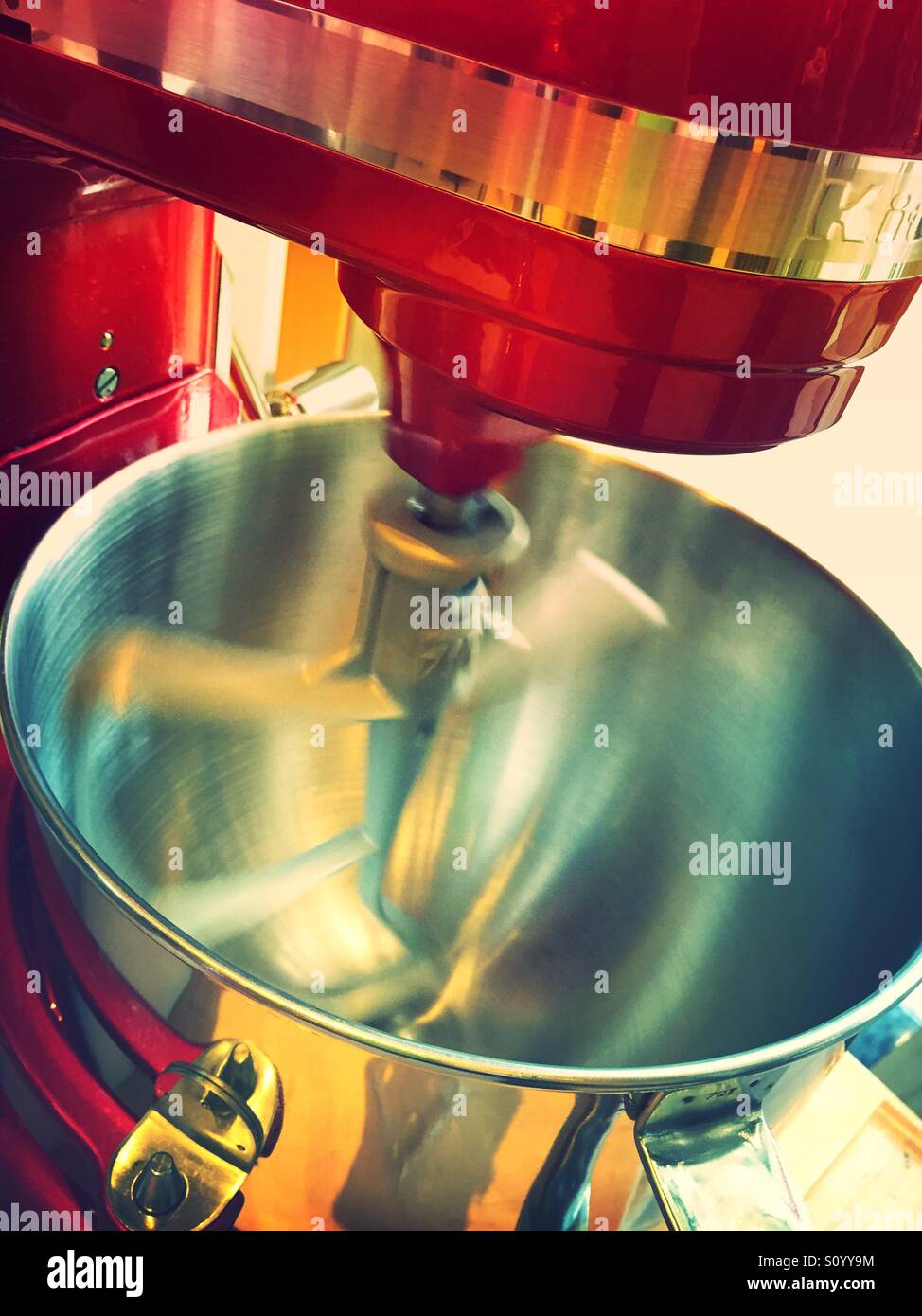 Electric mixer with blades rotating in mixer bowl - Smartphone Captured Stock Image