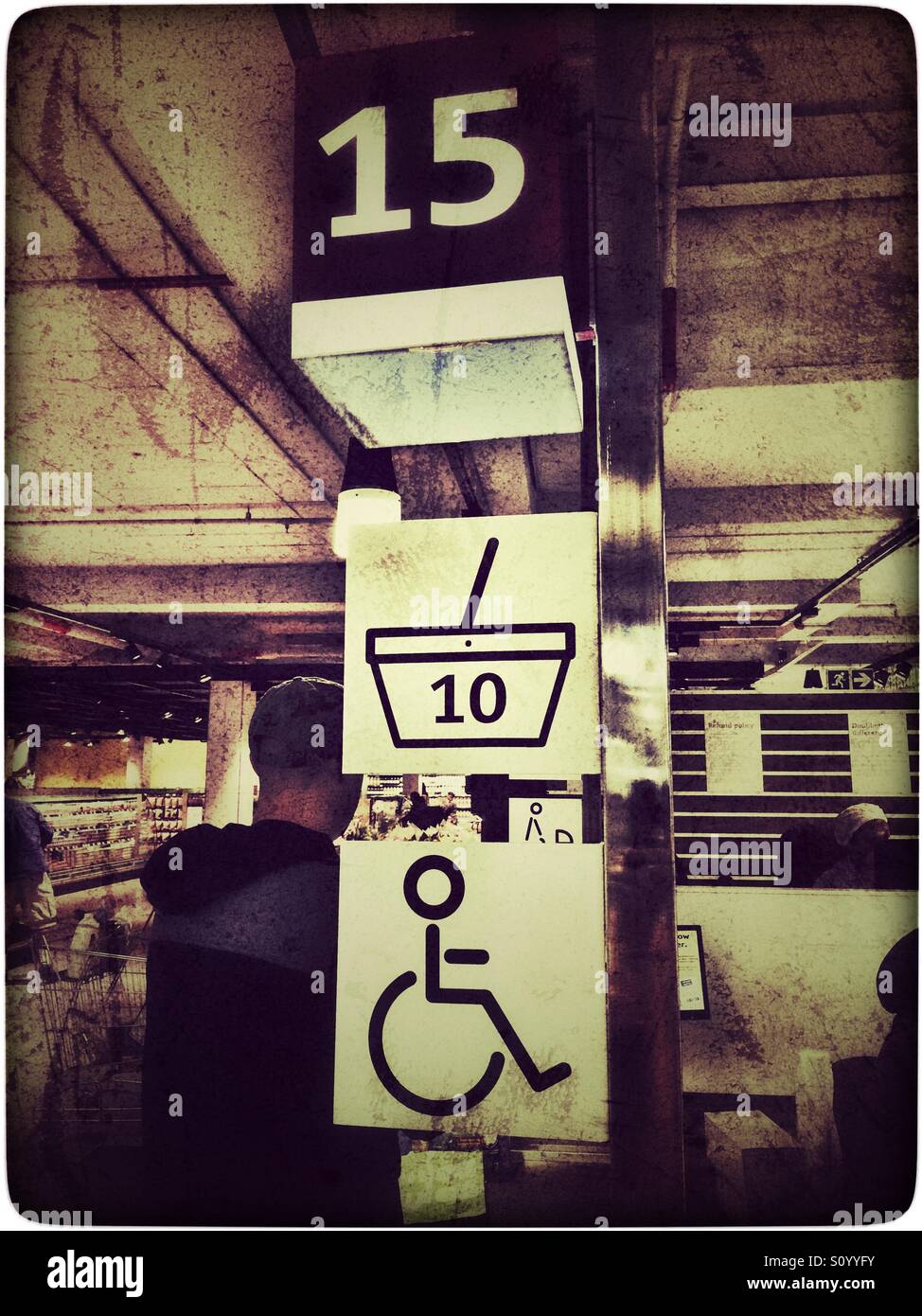 Wheelchair and express checkout in supermarket, heavy use of filters Stock Photo Alamy