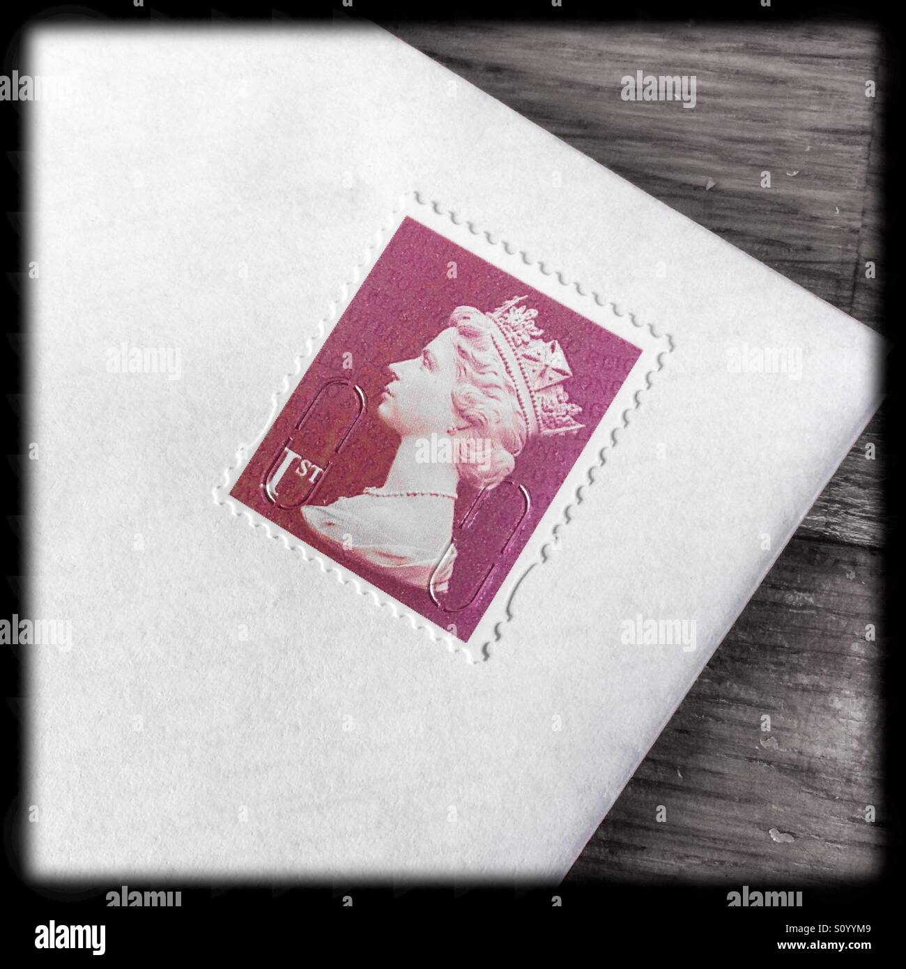 Close up view of a British first class stamp on a white envelope Stock Photo