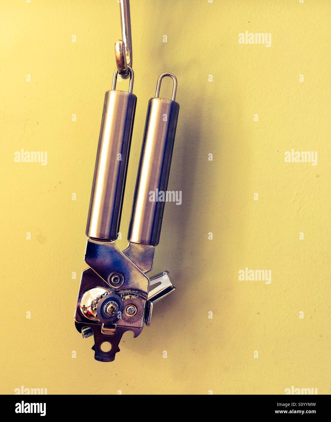 Close up view of a can opener hanging on a hook - Smartphone Captured Stock Image