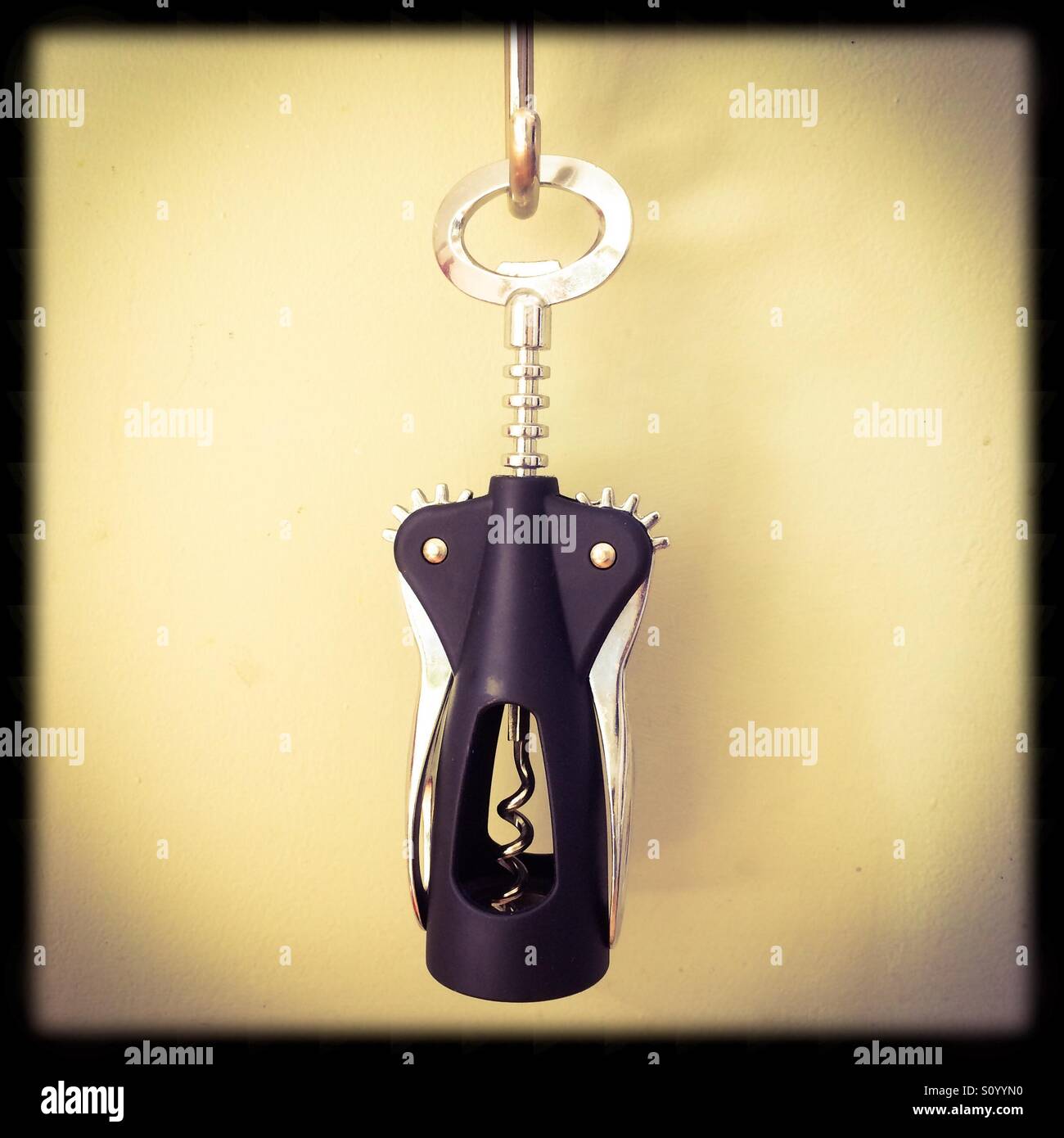 Close up view of a corkscrew hanging from a hook - Smartphone Captured Stock Image