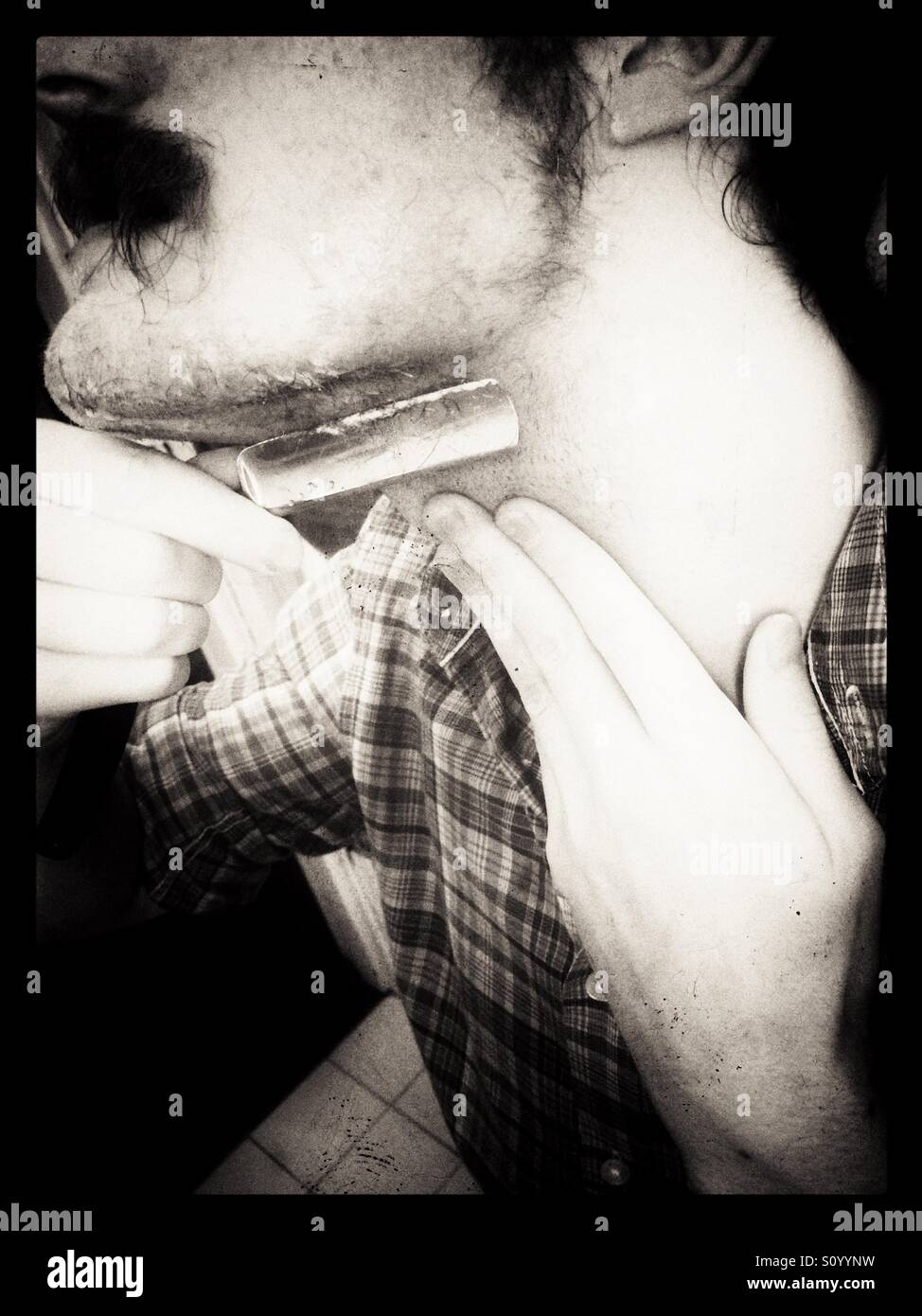 Shaving beard with cut-throat razor. - Smartphone Captured Stock Image