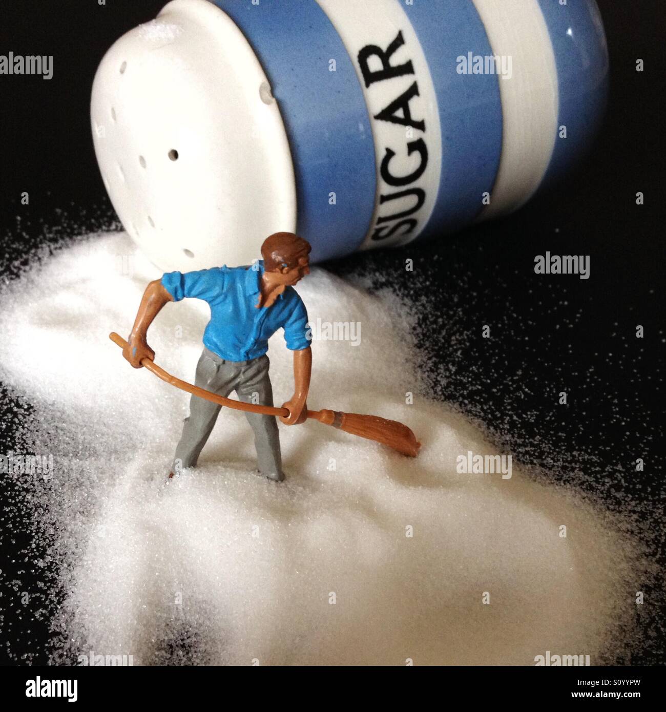 Man dealing with sugar spillage Stock Photo