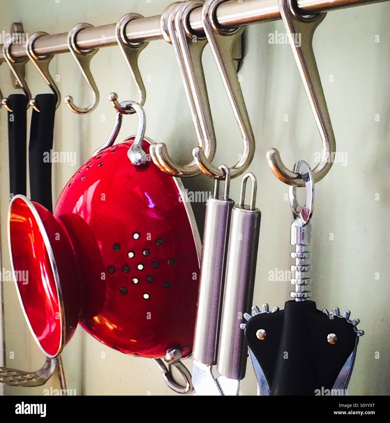 Kitchen utensils hanging on hooks in a kitchen Stock Photo Alamy