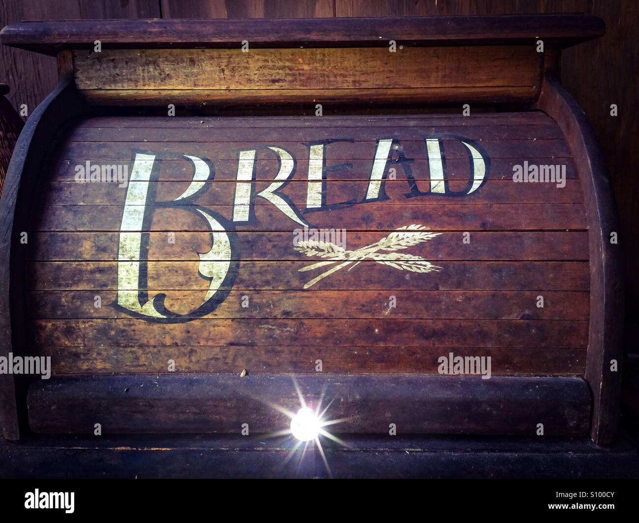 Very Old bread box with a painted sign. Almost a pictograph. Made of wood. Sliding cover. - Smartphone Captured Stock Image
