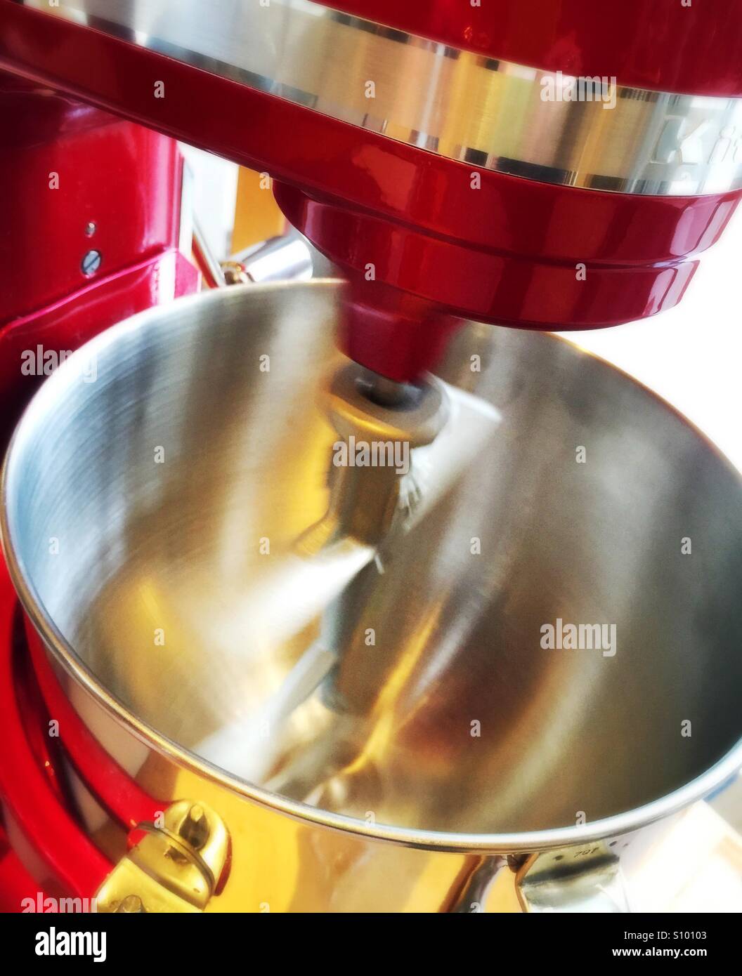 Electric mixer with rotating steel blades in metal bowl - Smartphone Captured Stock Image