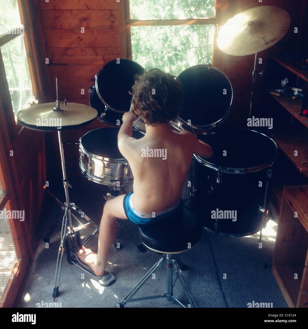 Seven year old boy rehearsing the drums - Smartphone Captured Stock Image