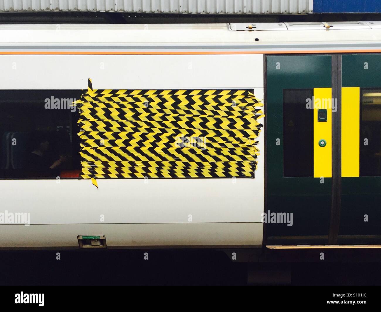 Black and yellow tape on train window - Smartphone Captured Stock Image