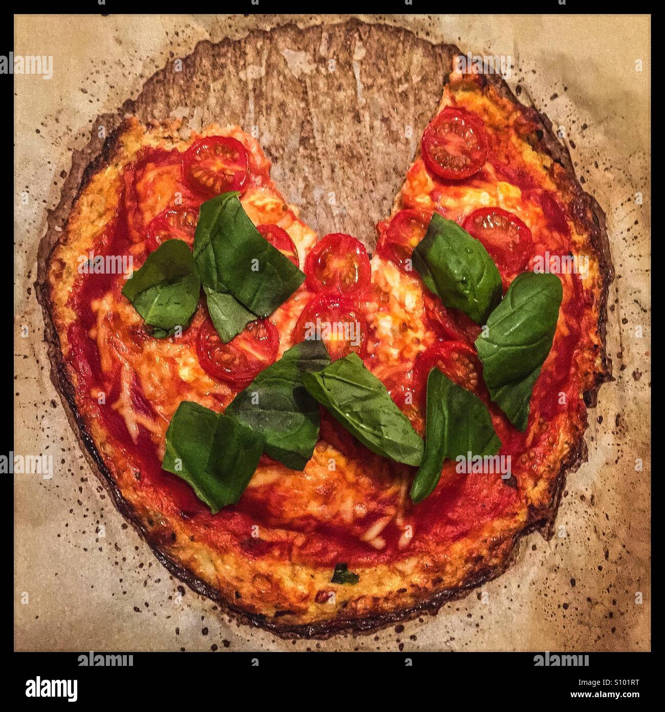 Cauliflower pizza with Basil and tomatoes Stock Photo